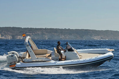 Man driving inflatable motorboat on open sea